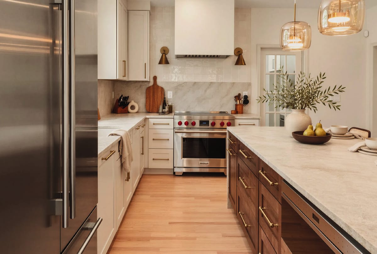 Kitchen with cream cabinetry and a wood island
