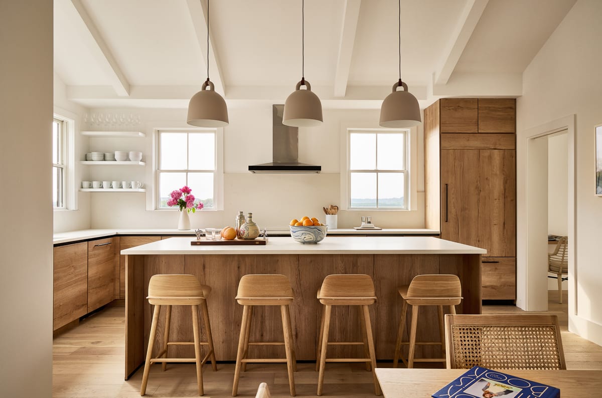 Open kitchen with oak cabinetry and pendant lights