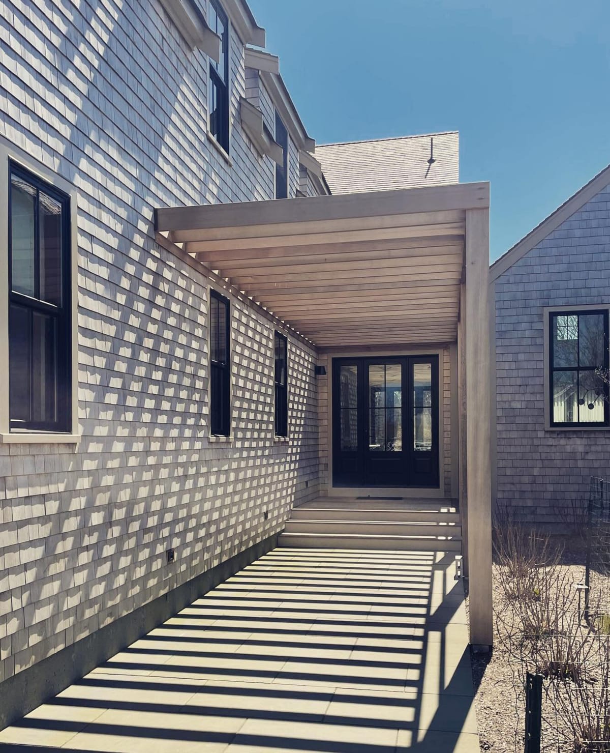 Pergola walkway casting striped shadows