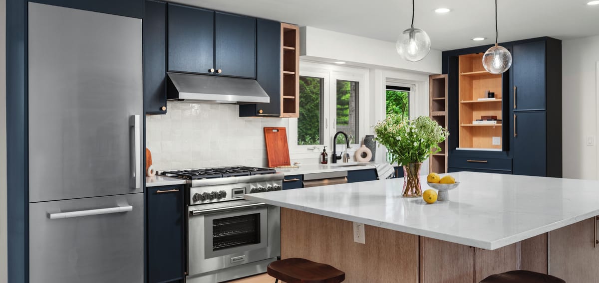 Blue kitchen with a white stone island