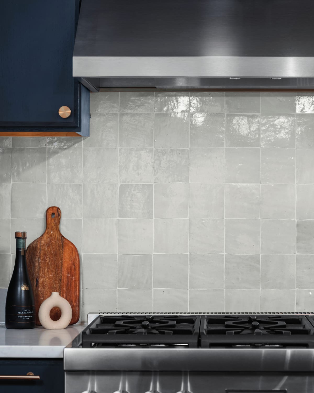 Range with handmade white tile backsplash