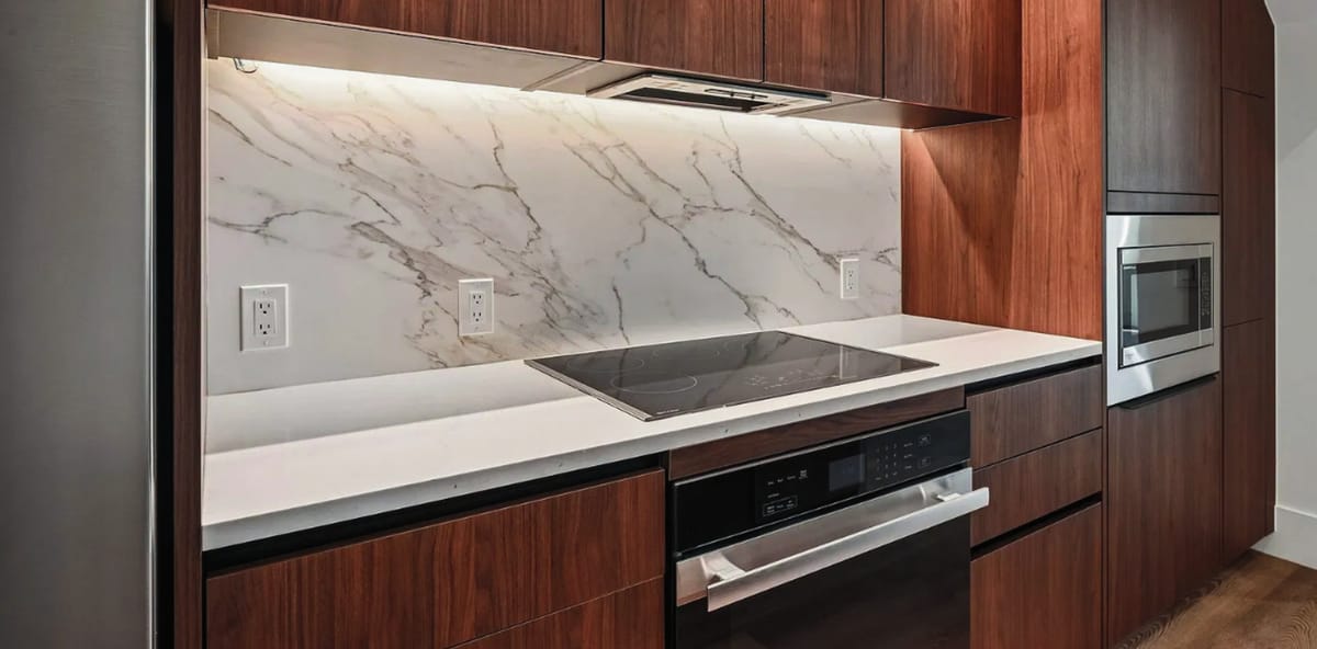 Walnut cabinetry with marble backsplash