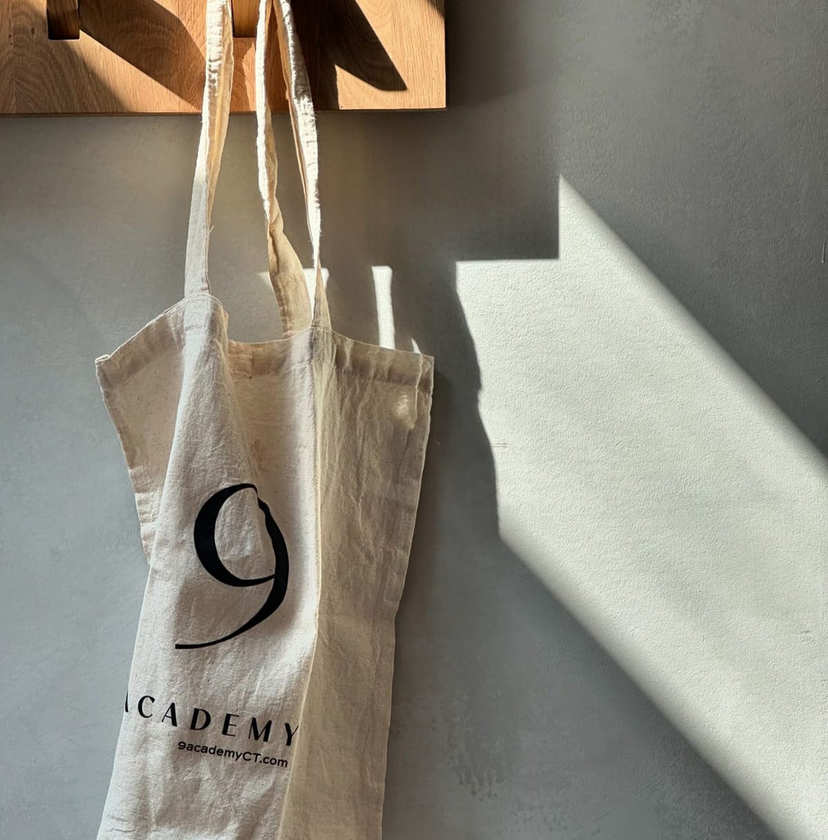 9 Academy tote bag hanging in the sun