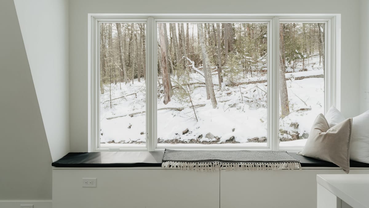 Window seat looking onto snowy woods